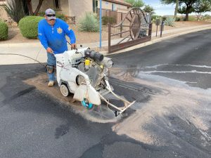 Moving Gate Systems cutting blacktop for traffic loops